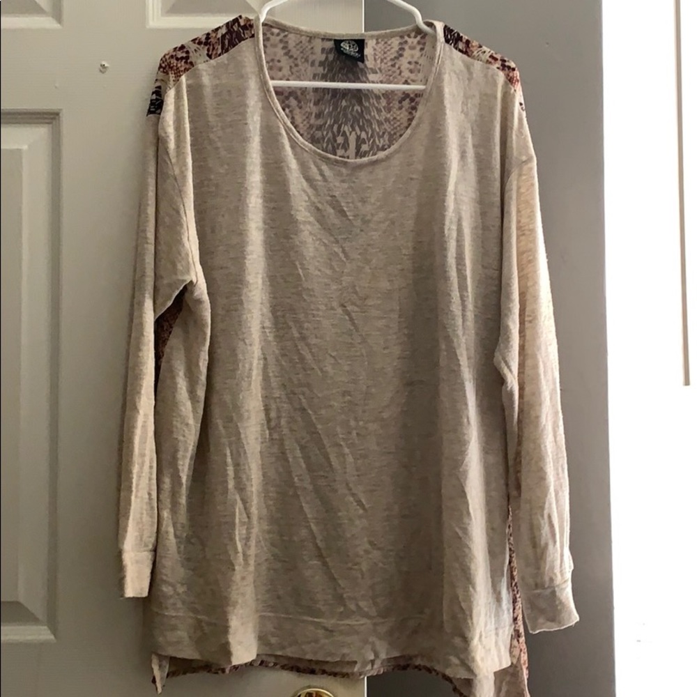 Tan top plain in front. Back has design